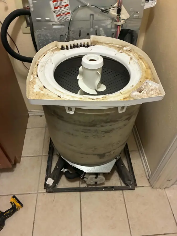 Top-Load Washer Full Tub Teardown: With the cabinet removed, the outer tub is exposed down to the suspension and base