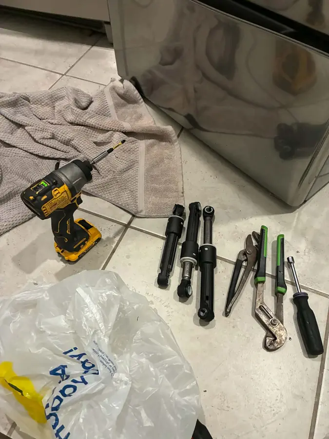 Suspension Repair, Ready to Install: Three new dampers laid out with the right tools for the job