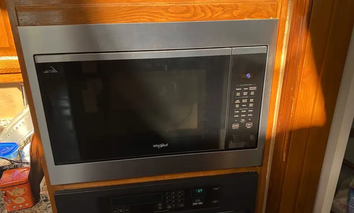 Whirlpool Built-In Microwave Repair: A built-in microwave with a trim kit, mounted above the wall oven