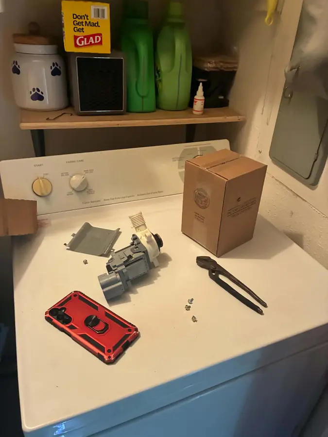 Whirlpool Top-Load Drain Pump Replacement: The failed drain pump sits next to its factory-certified replacement